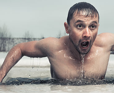 Man climbing out of frozen river